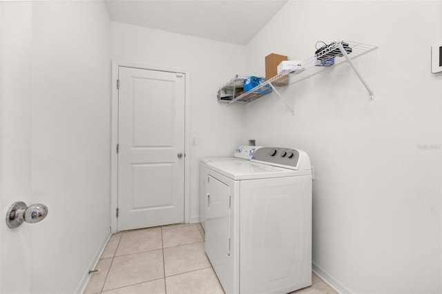 washroom with separate washer and dryer and light tile patterned floors