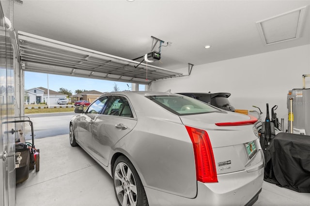 garage with a garage door opener and water heater