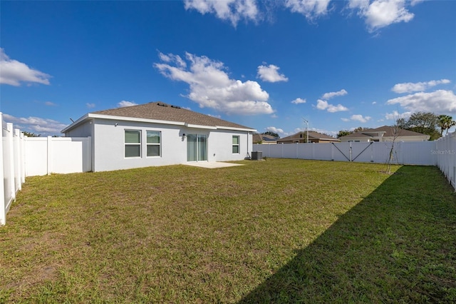 back of property featuring a lawn