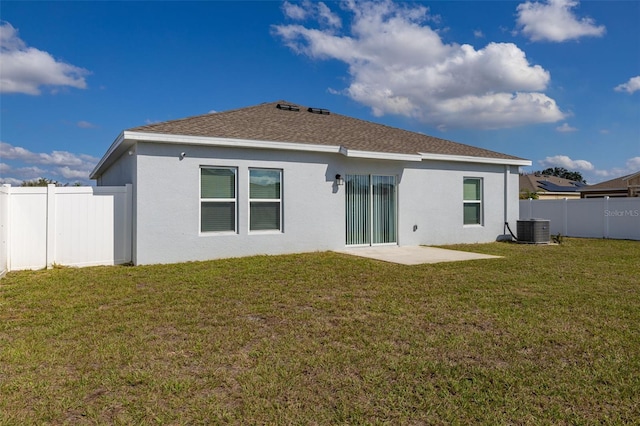 rear view of property featuring central AC unit, a lawn, and a patio