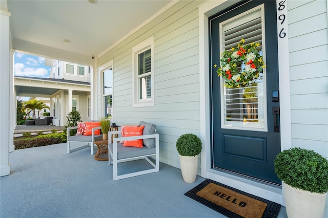 view of exterior entry featuring covered porch