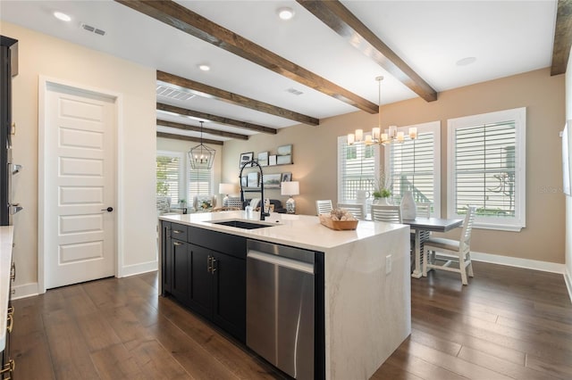 kitchen with pendant lighting, sink, dishwasher, a notable chandelier, and an island with sink