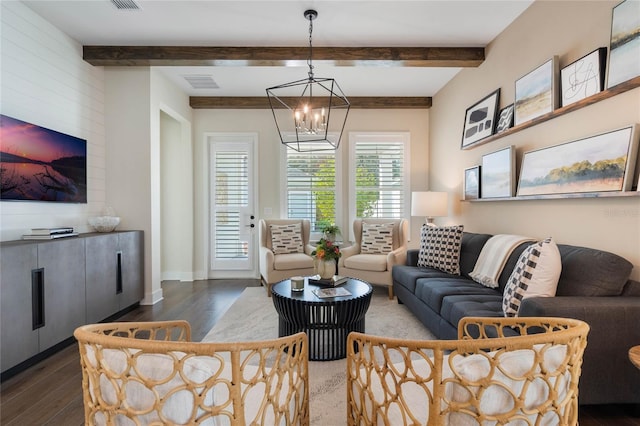 living room featuring dark hardwood / wood-style flooring, beam ceiling, and a notable chandelier