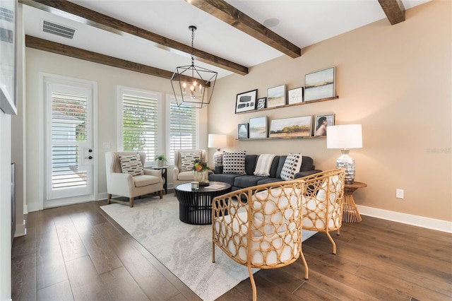 living room featuring beam ceiling, dark hardwood / wood-style floors, and an inviting chandelier