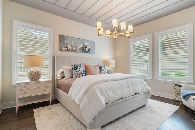 bedroom featuring an inviting chandelier and dark hardwood / wood-style floors