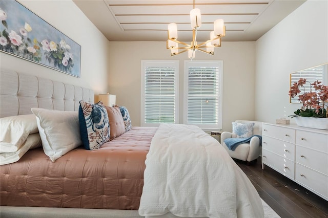 bedroom with a notable chandelier and dark hardwood / wood-style flooring