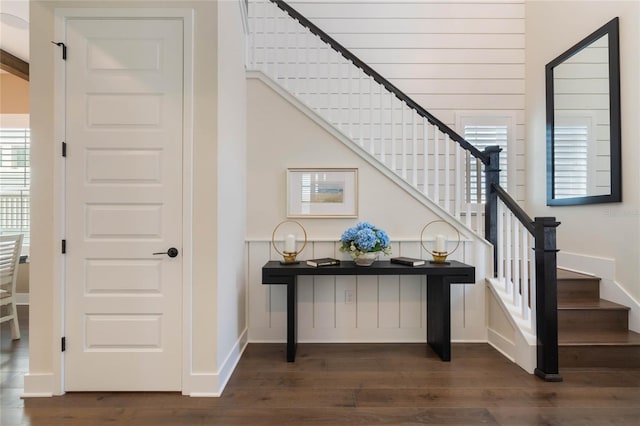 stairway with hardwood / wood-style floors and a wealth of natural light