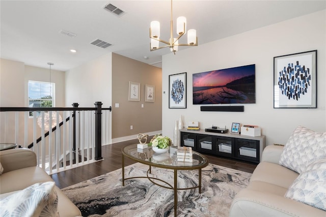 living room featuring dark hardwood / wood-style floors and a notable chandelier