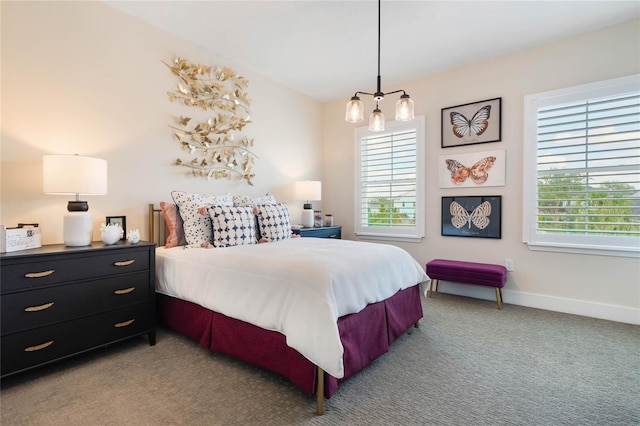 carpeted bedroom with an inviting chandelier