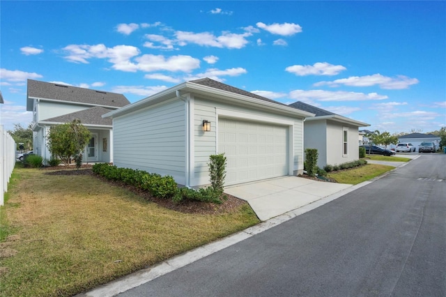 view of side of property with a garage and a yard