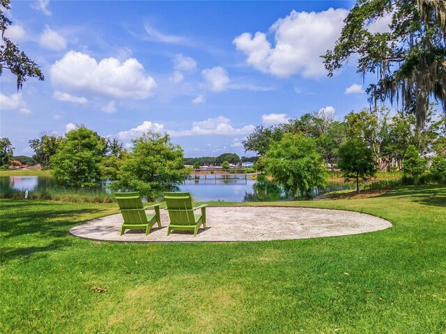 surrounding community featuring a lawn and a water view