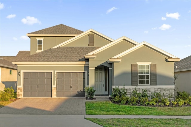 view of front facade featuring a garage and a front lawn