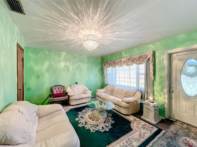 living room with an inviting chandelier and hardwood / wood-style flooring