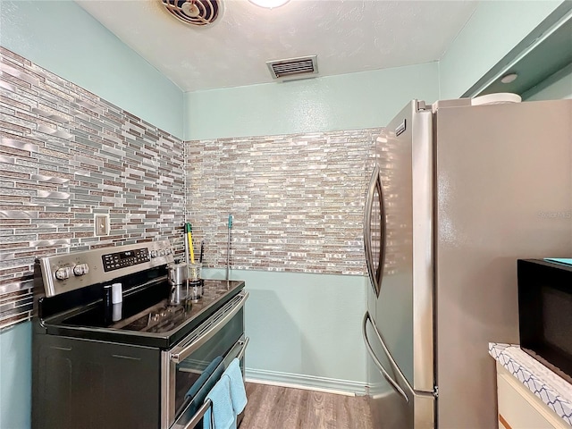 kitchen with stainless steel appliances and light hardwood / wood-style floors