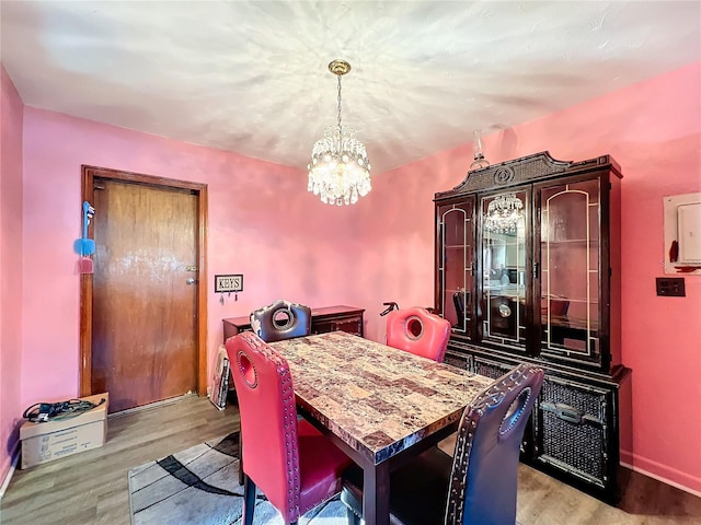 dining area featuring an inviting chandelier and light wood-type flooring