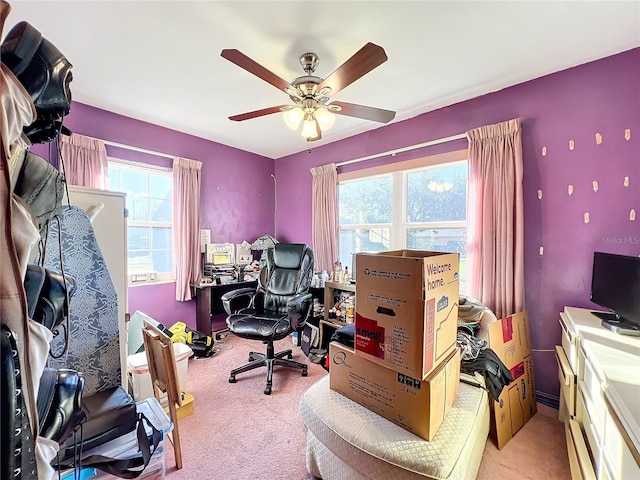 home office featuring light carpet and ceiling fan