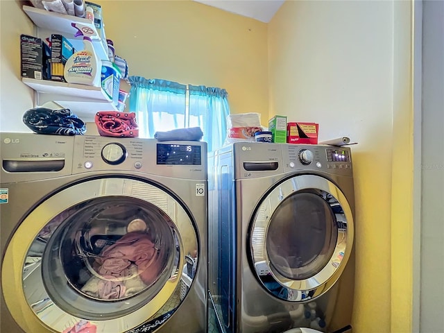 clothes washing area with independent washer and dryer