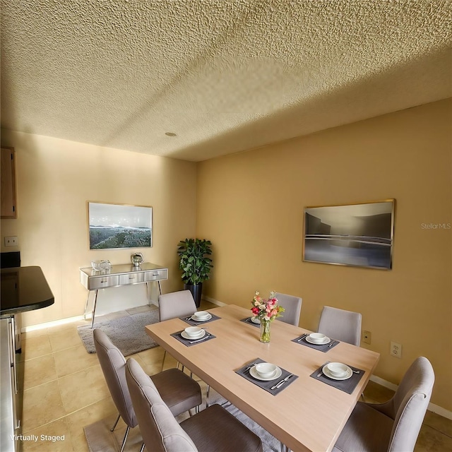 tiled dining room with a textured ceiling