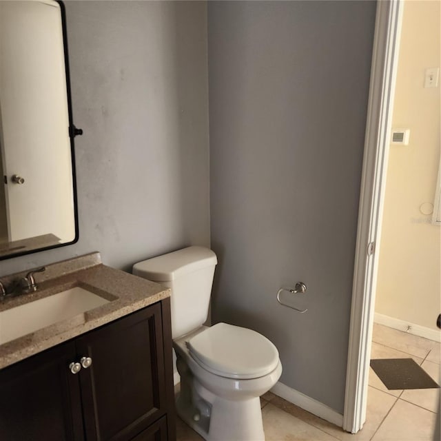 bathroom with vanity, tile patterned flooring, and toilet