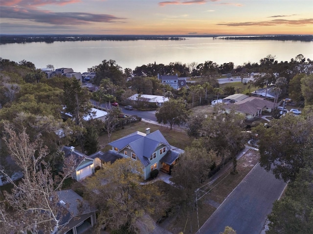 aerial view at dusk with a water view