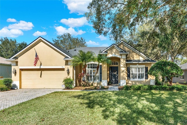 view of front of house featuring a garage and a front lawn