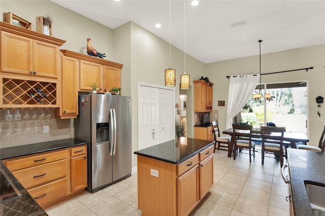 kitchen with a kitchen island, pendant lighting, stainless steel fridge, backsplash, and light tile patterned floors