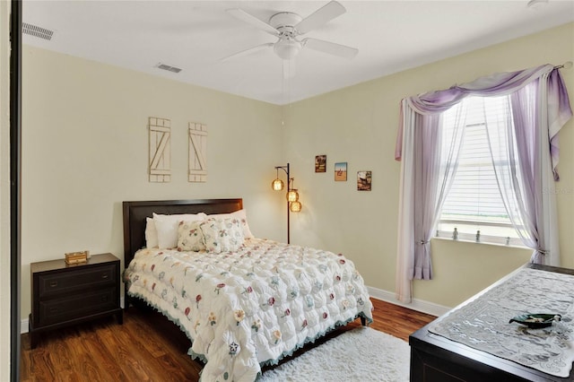 bedroom with ceiling fan and dark hardwood / wood-style floors