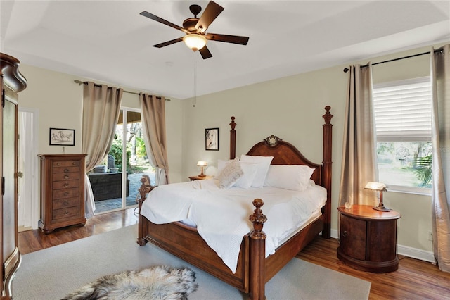 bedroom featuring ceiling fan, dark hardwood / wood-style flooring, and access to outside