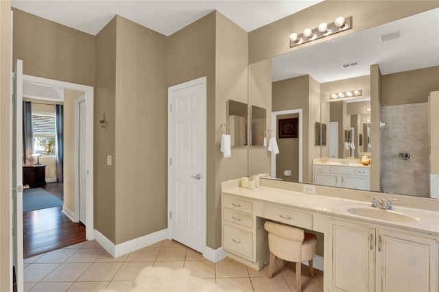 bathroom with vanity, tile patterned floors, and walk in shower