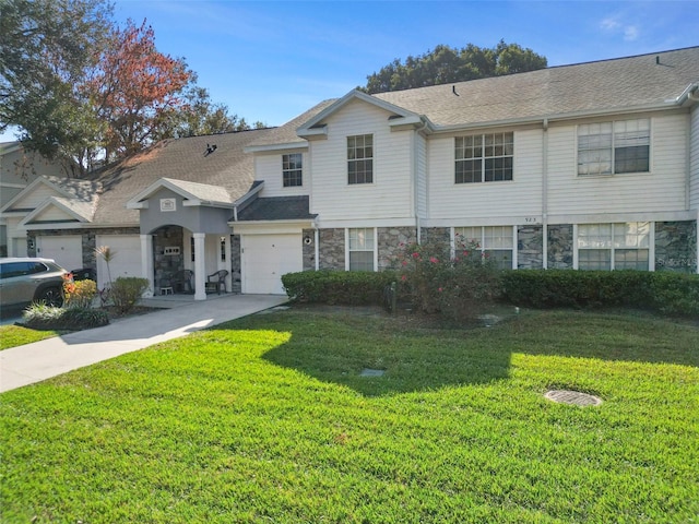 view of property with a garage and a front yard