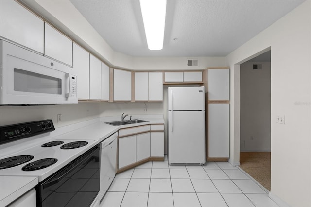 kitchen with white cabinetry, sink, and white appliances