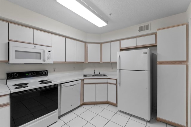 kitchen with white appliances, sink, a textured ceiling, and white cabinets