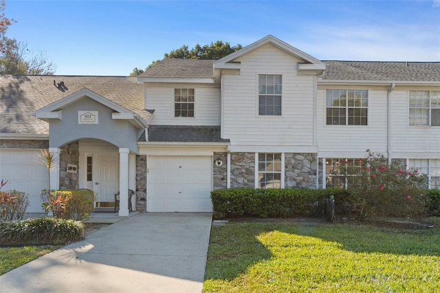 view of front of home featuring a garage and a front lawn