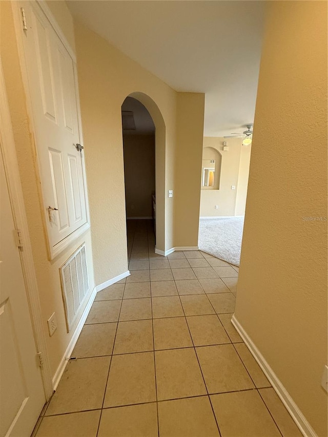 hall with light tile patterned floors