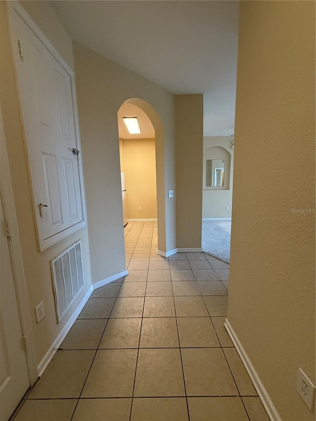 hallway featuring light tile patterned floors