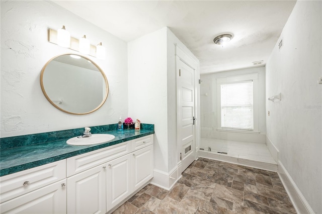 bathroom featuring vanity and a shower