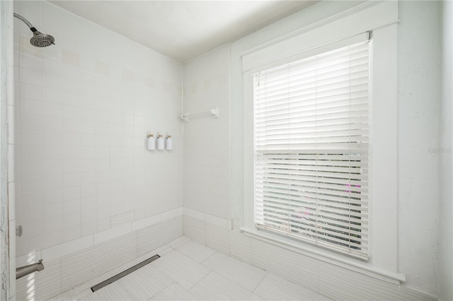 bathroom with a tile shower