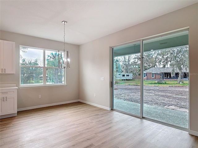 interior space featuring a chandelier and light hardwood / wood-style flooring