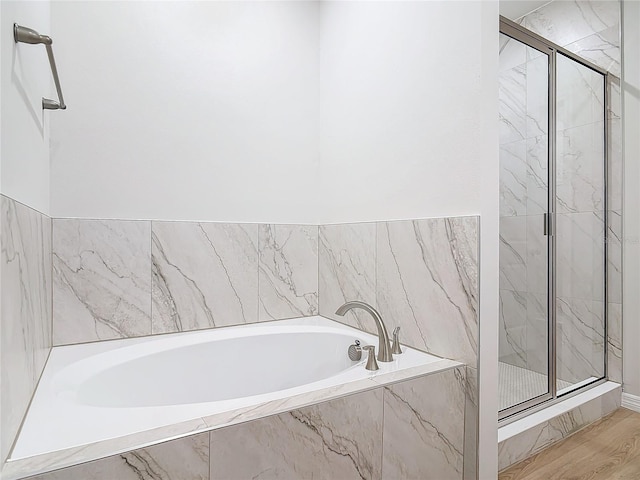 bathroom with wood-type flooring and plus walk in shower