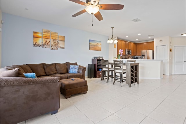 living room featuring light tile patterned flooring and ceiling fan