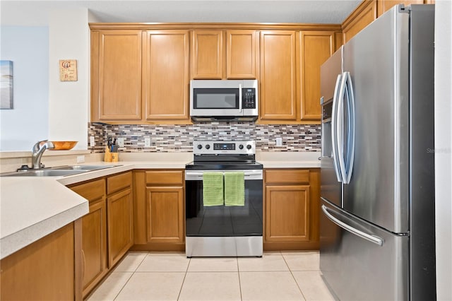 kitchen featuring tasteful backsplash, stainless steel appliances, sink, and light tile patterned floors