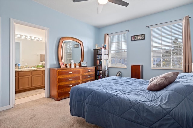 carpeted bedroom featuring connected bathroom and ceiling fan