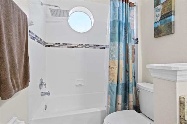 bathroom featuring shower / bathtub combination with curtain and toilet