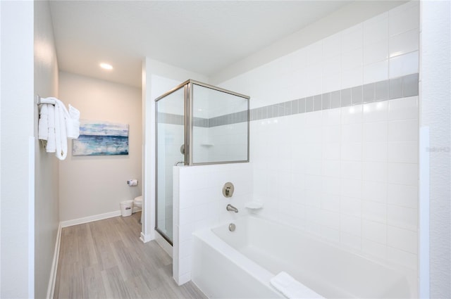 bathroom featuring hardwood / wood-style flooring, shower with separate bathtub, and toilet