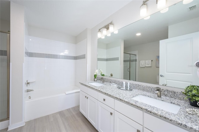 full bathroom featuring shower with separate bathtub, vanity, and toilet