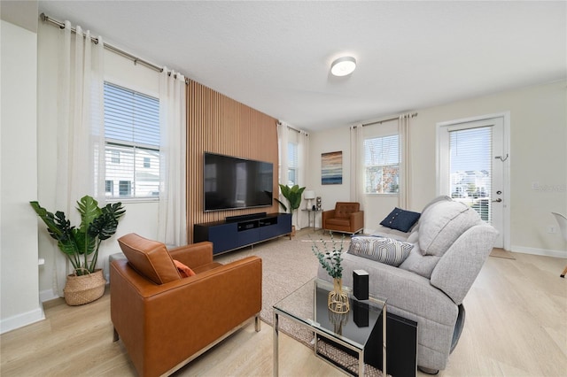 living room with plenty of natural light and light wood-type flooring