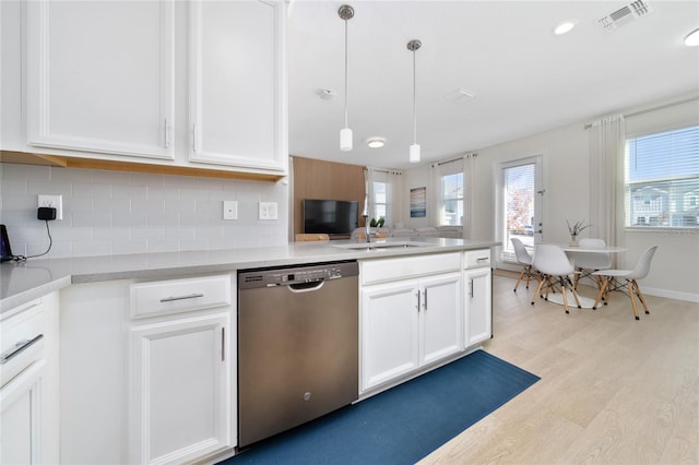 kitchen with white cabinetry, dishwasher, sink, and decorative light fixtures