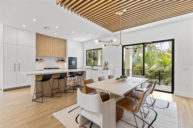 dining space featuring sink and light hardwood / wood-style floors