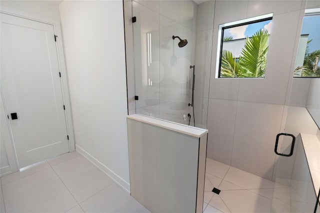 bathroom featuring tile patterned floors and a shower with shower door