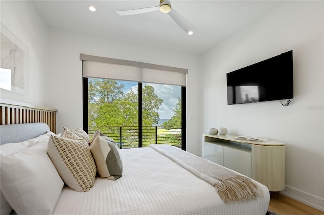 bedroom with ceiling fan, wood-type flooring, and access to exterior